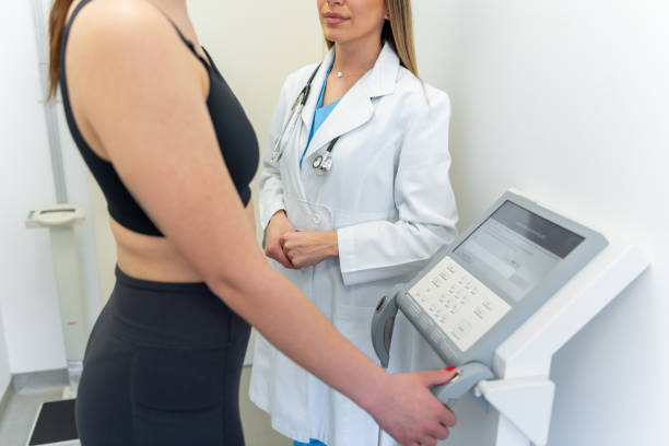istock Compassionate healthcare professional conducting a body composition analysis in a modern clinic 2153792509