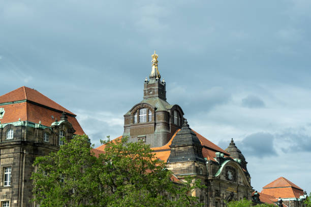 A large building with a gold statue on top