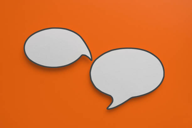 For conceptual image about communication and social media, customer feedback, real blank white speech bubble paper cut on orange background