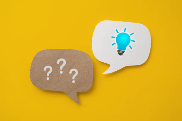 istock question mark sign and bright lightbulb sign on real speech speech bubble paper cut on yellow background, for FAQ , Frequently asked questions concept 2153796517