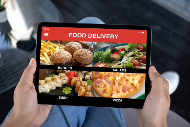 istock male hands holding computer tablet with app food delivery screen 2153797727