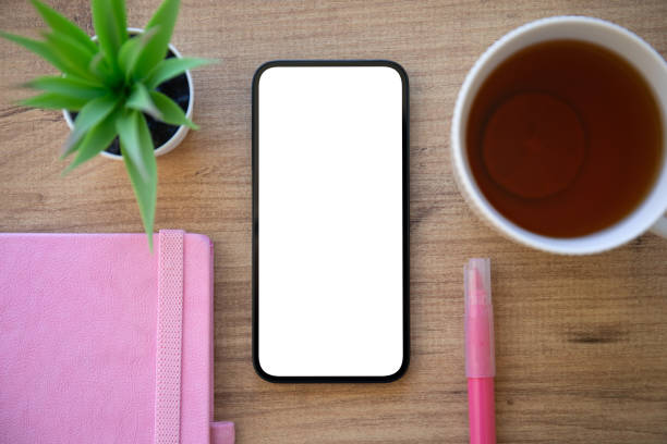 istock phone with isolated screen wooden table pink notepad in cafe 2153797862