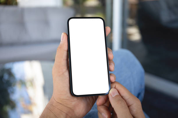 istock Male hands holding phone with screen isolated in office 2153798204