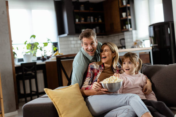 istock Family Movie Night: Engrossed in Thrilling Scenes at Home 2153798211