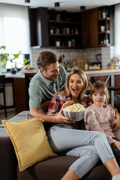 istock Family Movie Night: Engrossed in Thrilling Scenes at Home 2153798226