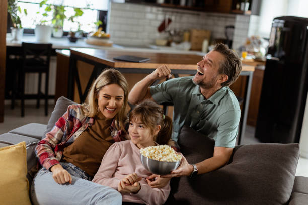 istock Family Movie Night: Engrossed in Thrilling Scenes at Home 2153798240