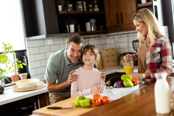 istock Joyful Family Prepares Breakfast Together in a Sunlit Modern Kitchen 2153798254