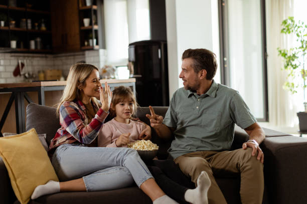 istock Cozy family time: sharing laughter and popcorn on a casual evening 2153798285