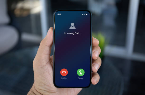 istock man hand hold phone with incoming call screen in office 2153798437