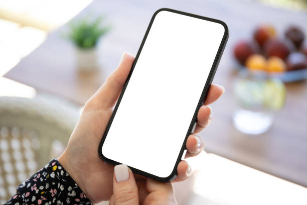 istock female hand hold phone with isolated screen background table cafe 2153798448