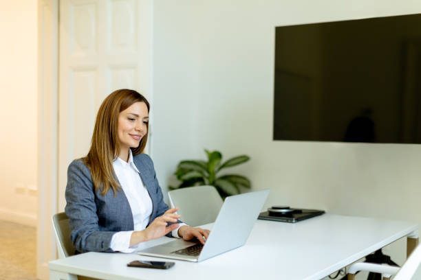 istock Professional woman engaging in business activities at a modern office space during work hours 2153799088