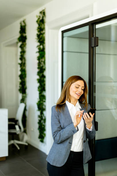 istock Professional woman engaging in a phone conversation in a modern office space 2153799092