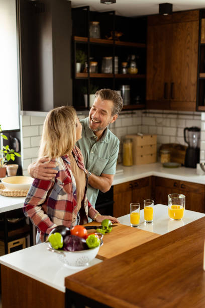istock Joyful Couple Sharing a Moment Over Breakfast in a Modern Kitchen. Generative AI 2153799434