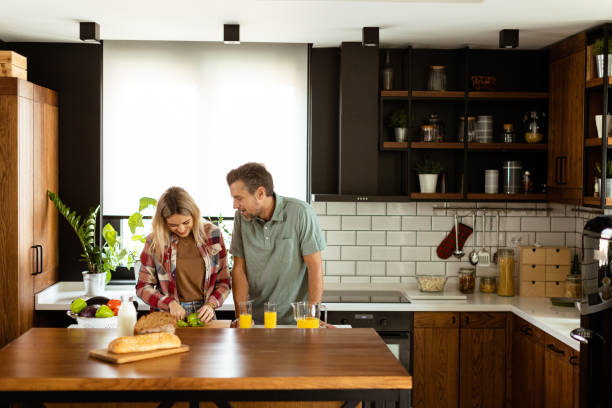 istock Joyful Couple Sharing a Moment Over Breakfast in a Modern Kitchen. Generative AI 2153799444