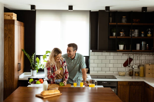 istock Joyful Couple Sharing a Moment Over Breakfast in a Modern Kitchen 2153799446