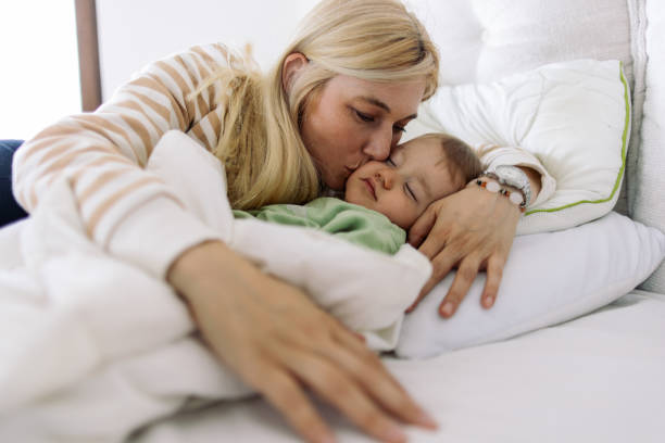 istock Mother sleeping in bed with her son 2153801385