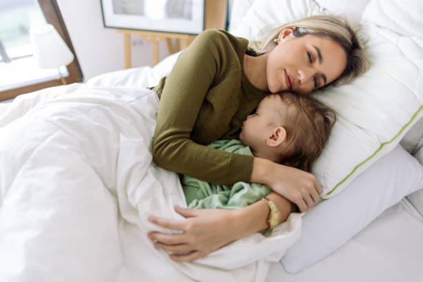 istock Young woman taking a nap with her nephew 2153801393