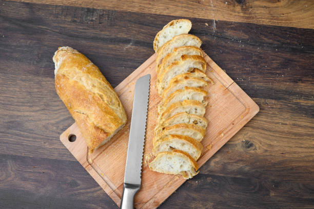 istock Sliced ​​white bread, long wheat baguette, on a cutting board 2153802998