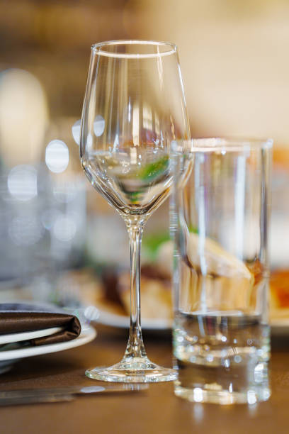 istock An empty wine glass and a glass on the served dining table. 2153803320