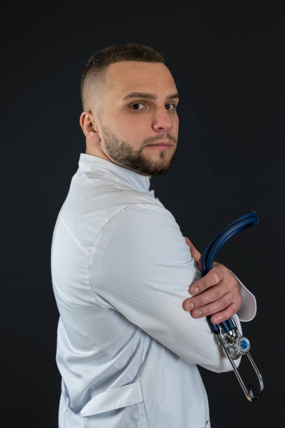 istock Male physician in white coat with stethoscope isolated 2153806578
