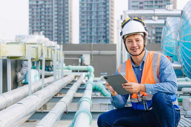 istock portrait gas pipe engineer worker on site service working maintenance hot water tank at roof top outdoor commercial building happy smiling. 2153809964