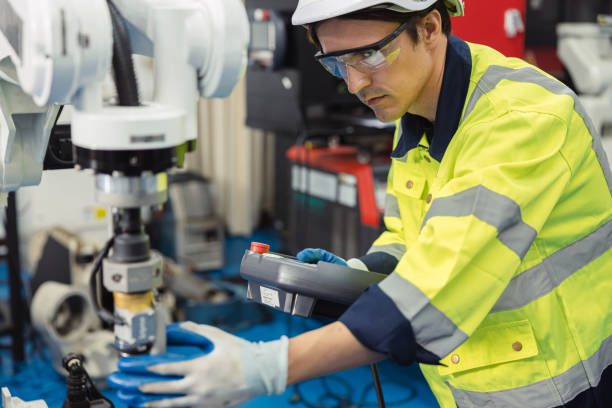 istock Engineer young man university student learn to control operate industry robot welding arm in robotics engineers lab classroom in polytechnic education. 2153809980
