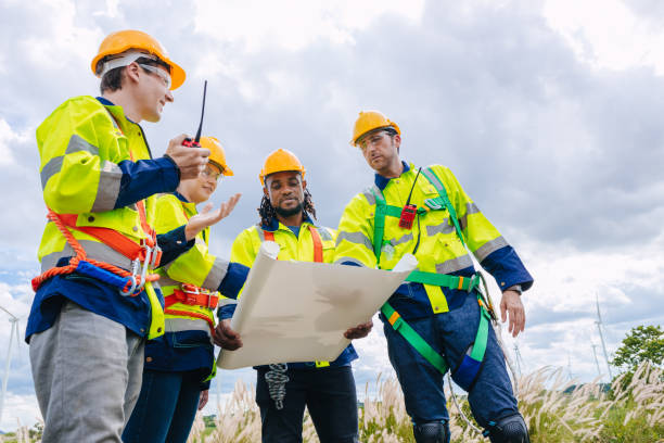 istock Engineer team working group survey at wind turbine clean power generator service maintenance wind mill outdoor. 2153810018