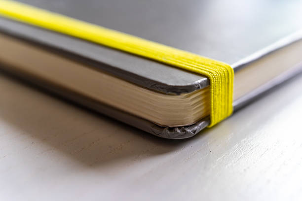 A shot of a Notebook with Yellow Rubber Band Close up