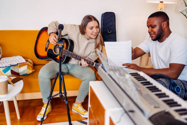 istock Two young musicians making music at home 2153812728