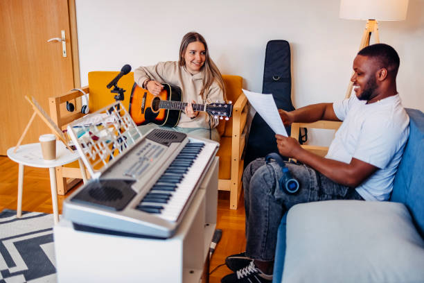 istock Two young musicians making music at home 2153812732