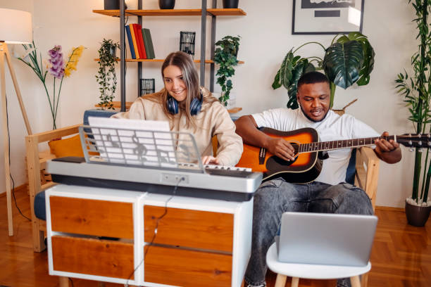 istock Two young musicians making music at home 2153812983