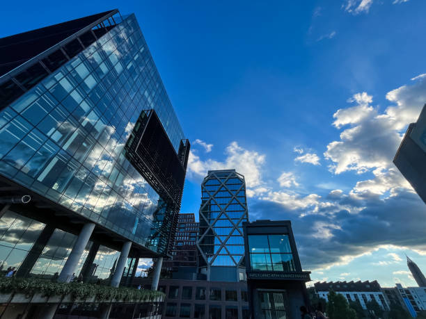 istock Modern buildings reflecting clouds and a blue sky 2153813741