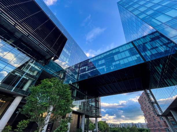 istock Modern buildings reflecting clouds and a blue sky 2153813765