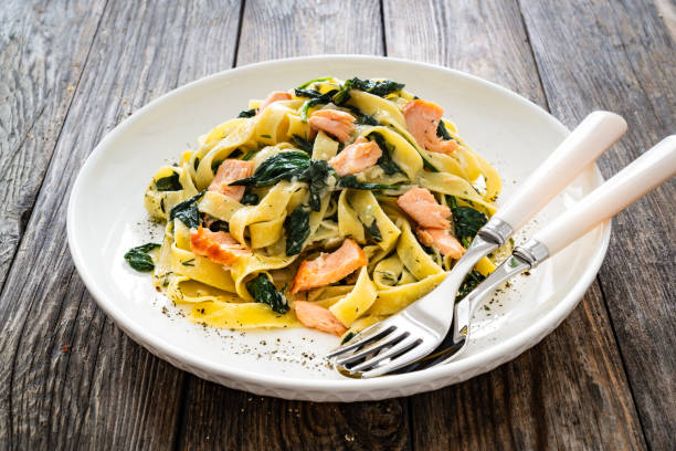 istock Pappardelle with grilled salmon and spinach on wooden table 2153814095
