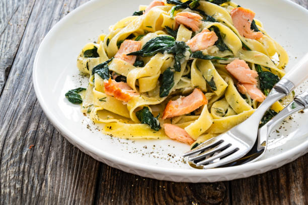 istock Pappardelle with grilled salmon and spinach on wooden table 2153814173