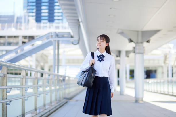 istock Japanese high school girl wearing summer uniform while commuting to school 2153815520