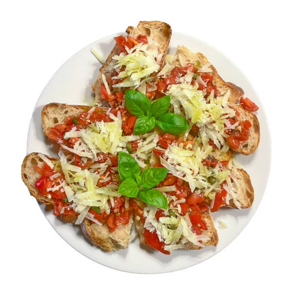 Bruschetta, a typical Italian appetiser. Toasted white bread with chopped tomatoes, garlic, fresh basil and sprinkled with Parmesan (bruschetta con pomodoro e basilico).