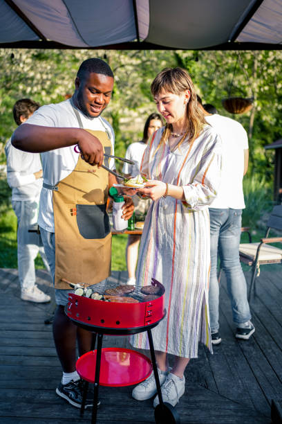 istock Friends having a barbecue party in a backyard 2153820463