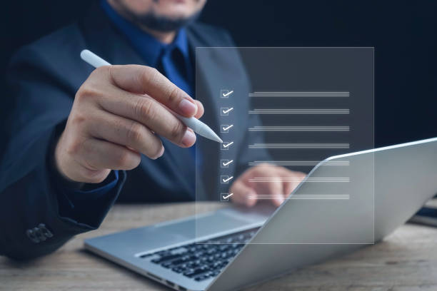 istock Checklist, Digital and smart checklist document concept, Businessman marking on e-checklist on virtual screen and use laptop document management with modern intelligent online systems high security. 2153822512