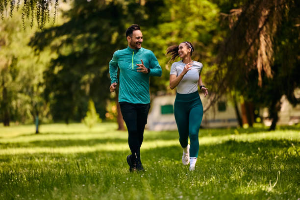 istock Happy athletic couple talking while jogging in the park. 2153823050