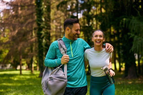 istock Happy athletic couple having fun while walking in the park. 2153823079