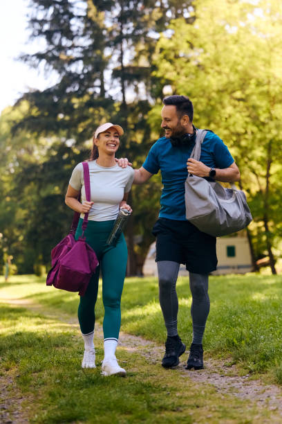 Happy athletic couple having fun while going on sports training in nature.