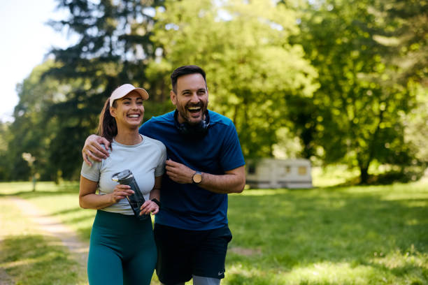 istock Cheerful athletic couple having fun while exercising in nature. 2153823829