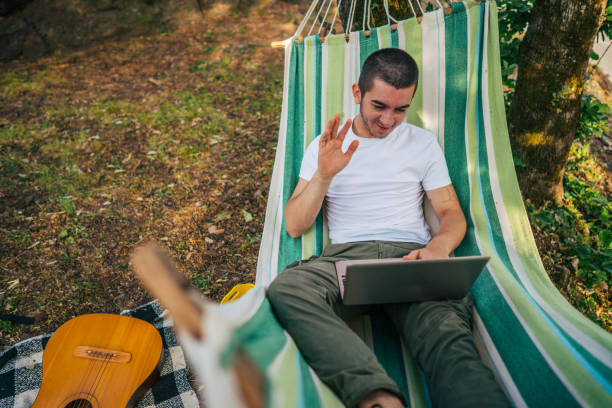 istock Happy young man working online at the countryside using a laptop computer. 2153823940