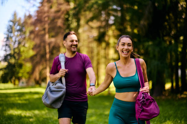 istock Happy athletic couple holding hands while going on sports training in nature. 2153823970