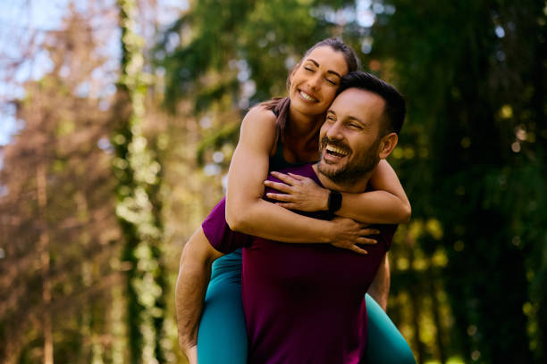 istock Happy athletic couple piggybacking while working out in the park. 2153824022