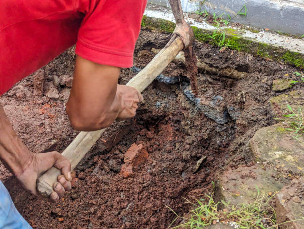 istock A Man uses a pickaxe to digging ground in a garden 2153827137