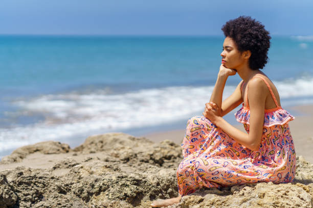 istock Thoughtful black woman admiring sea 2153827491