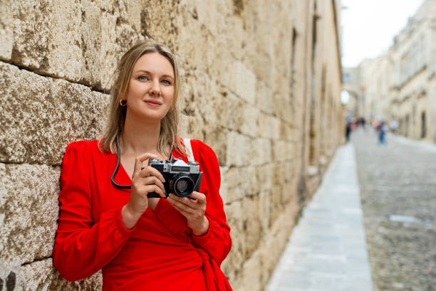 Woman with a retro camera on the street.