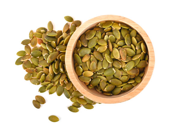istock Pumpkin Seed in wood bowl isolated on white background top view 2153828929